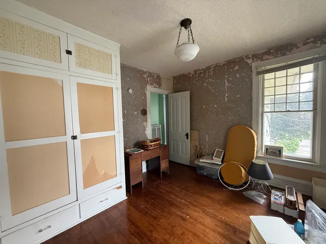 a workspace with wooden floor and windows