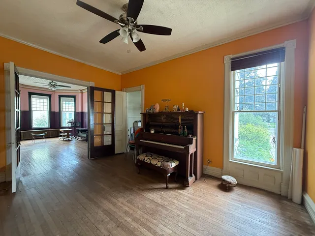 a living room with furniture and a wooden floor