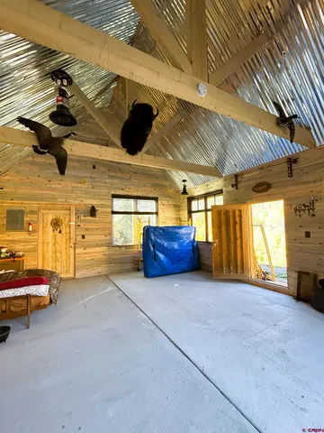 a view of a backyard with furniture and a garden