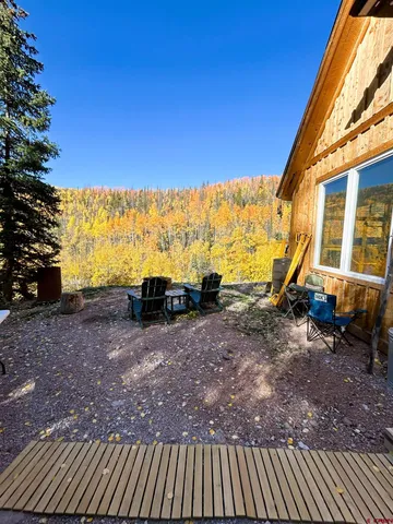 a view of a house with backyard and sitting area