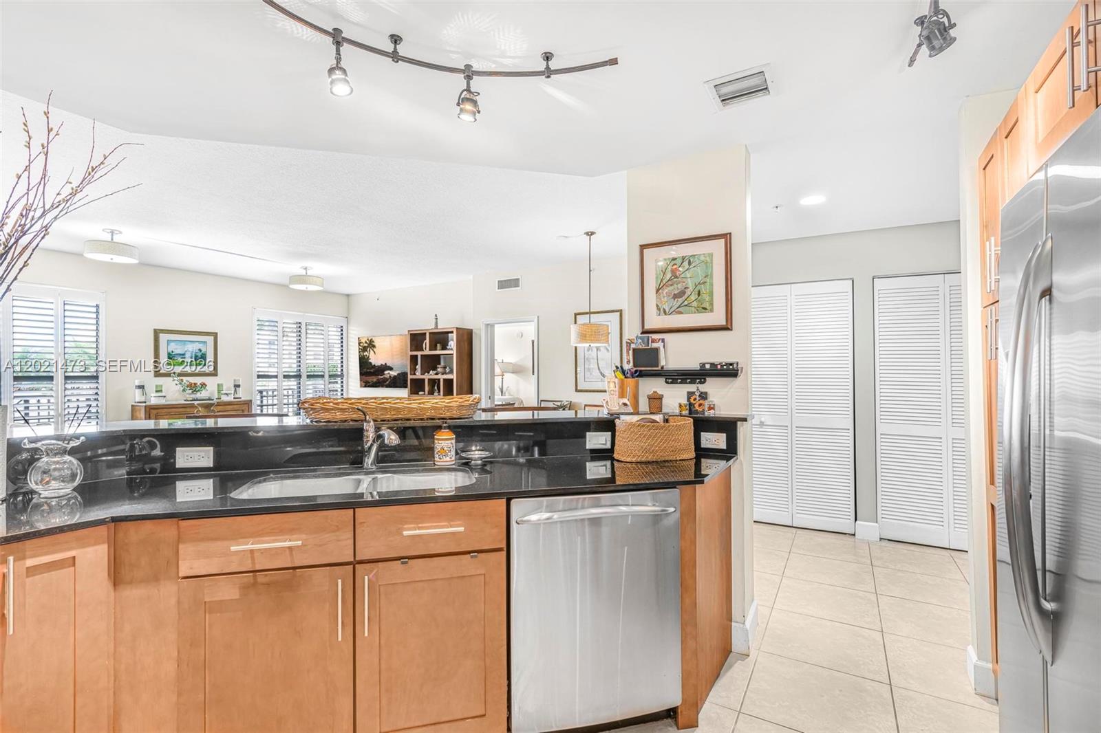 8395 Southwest 73rd Avenue, Unit 710 Miami, FL 33143 - Photo 15 of 32 a kitchen with stainless steel appliances granite countertop a refrigerator and a sink