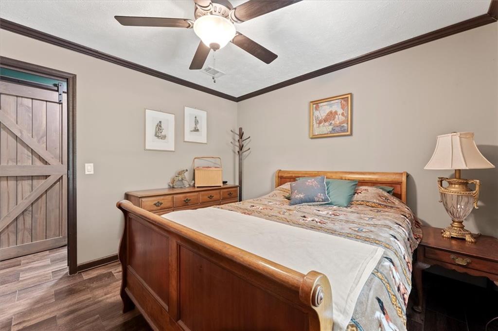 170 Anoia Road Washington, GA 30673 - Photo 26 of 46 a bed room with a bed and a chandelier