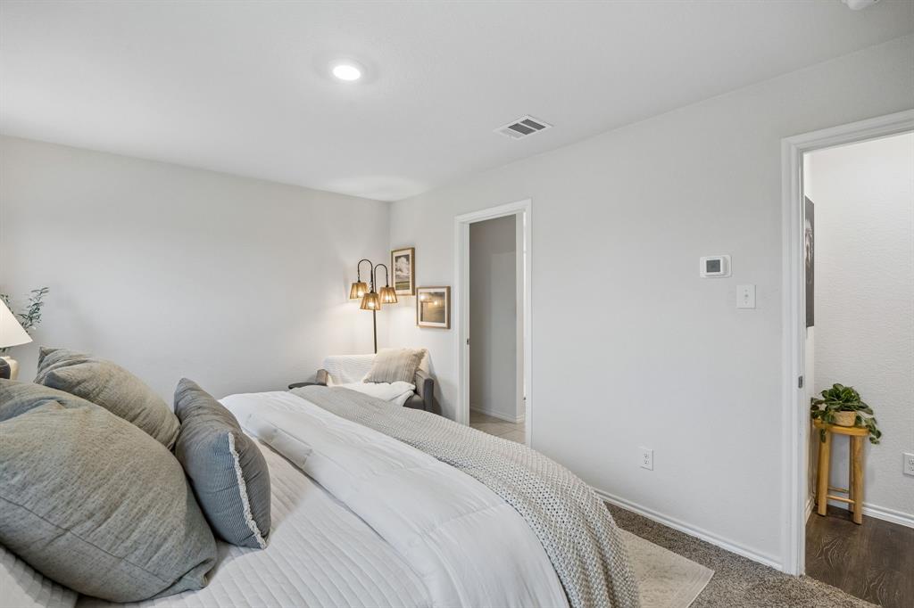 1107 Ringgold Road Forney, TX 75126 - Photo 18 of 27 Primary bedroom featuring neutral gray walls, recessed lighting, and carpet flooring