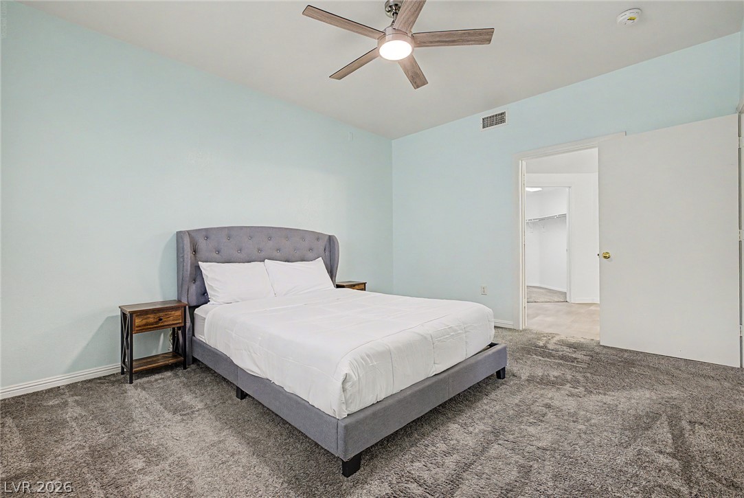 2153 Quarry Ridge Street, Unit 103 Las Vegas, NV 89117 - Photo 21 of 42 A comfortable bedroom featuring soft carpeting and an integrated ceiling fan.