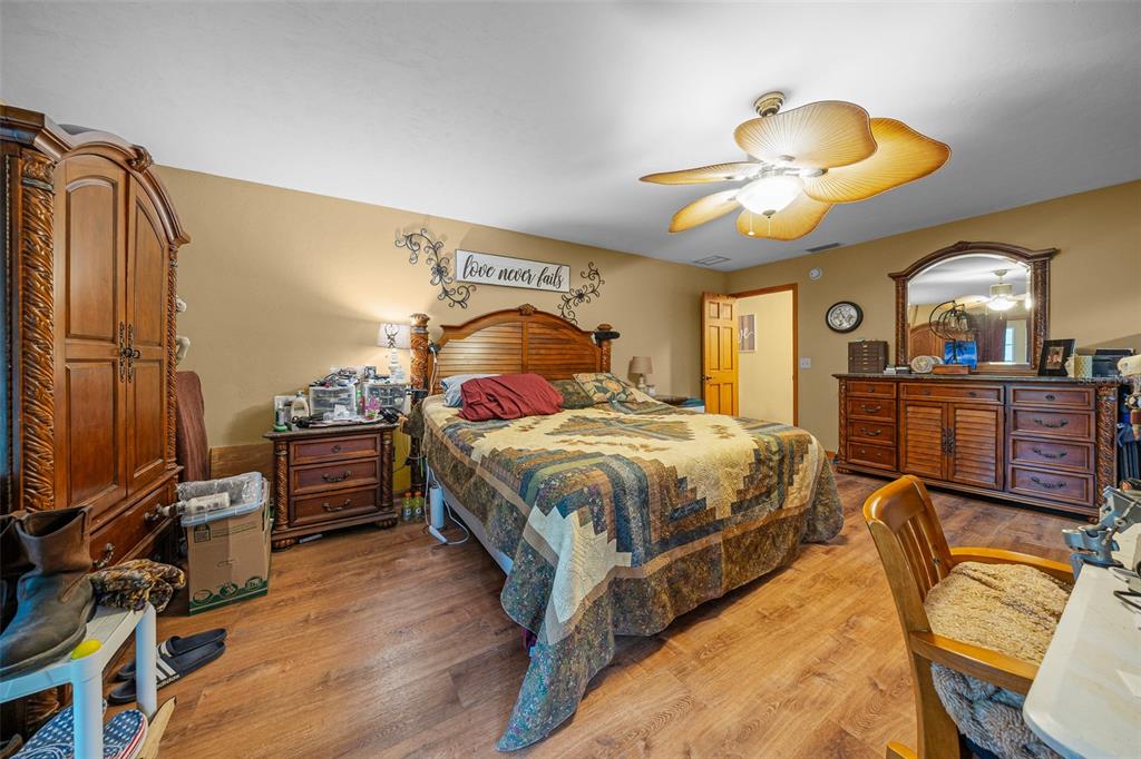 732 Carl Wilson Road Fort White, FL 32038 - Photo 18 of 80 a bedroom with a bed and wooden floor