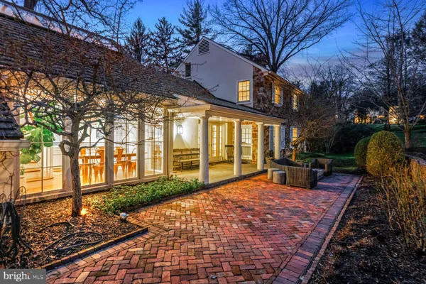 a view of a house with backyard and sitting area
