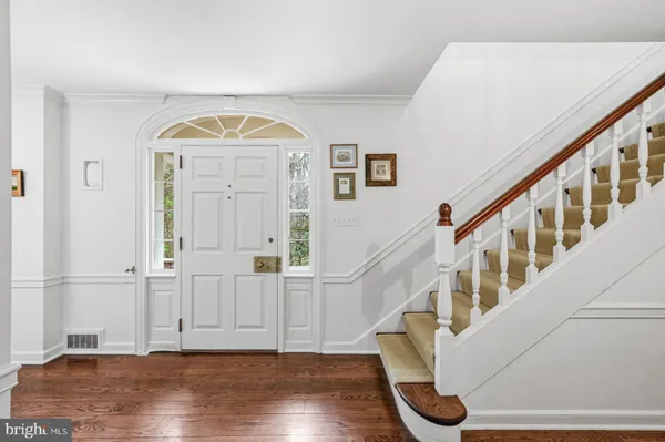 a kitchen with stainless steel appliances a white stove top oven a sink dishwasher with wooden floor and cabinets