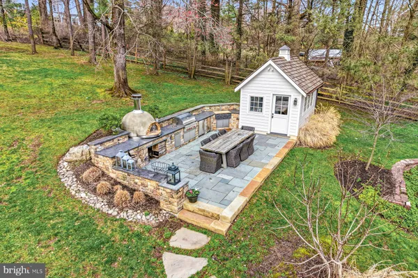a view of a patio with couches chairs and a yard