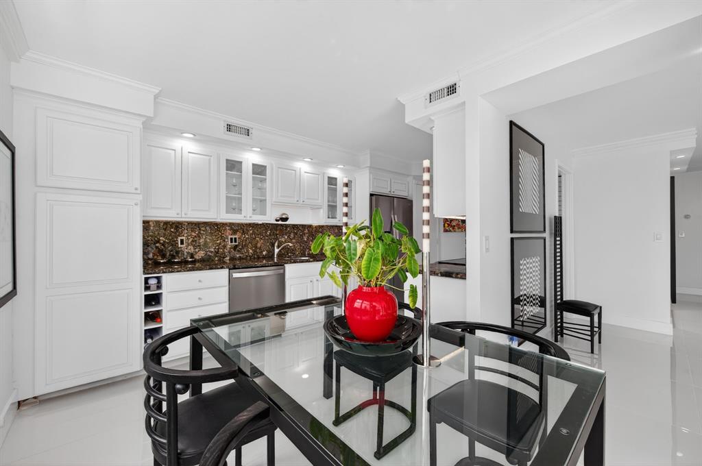936 Intracoastal Drive, Unit 3C Fort Lauderdale, FL 33304 - Photo 19 of 82 a kitchen with a table and chairs
