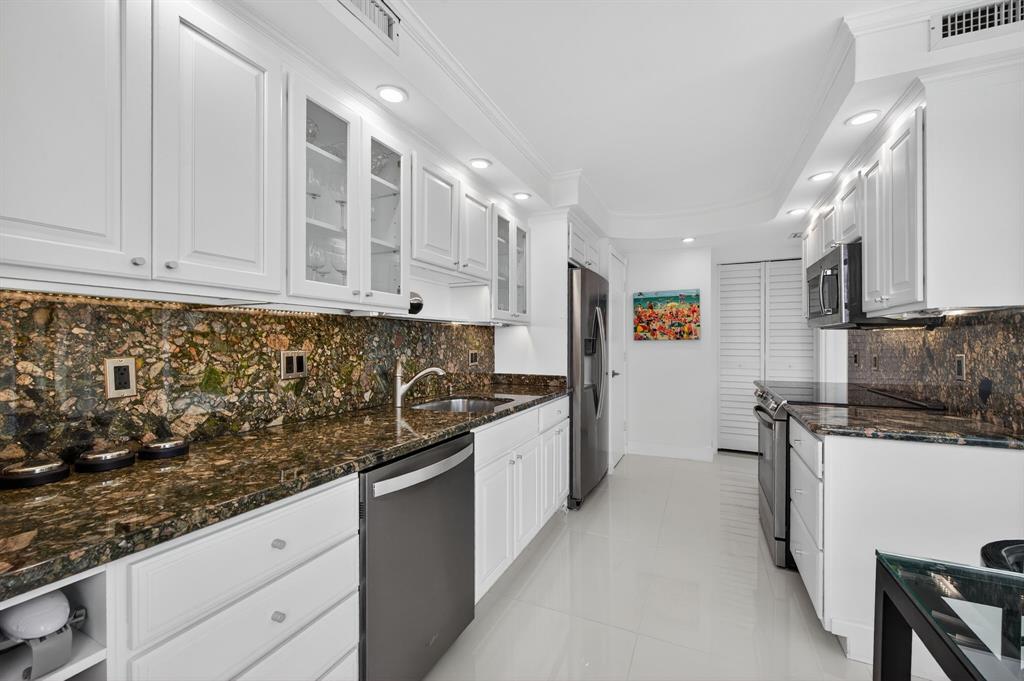 936 Intracoastal Drive, Unit 3C Fort Lauderdale, FL 33304 - Photo 23 of 82 a kitchen with stainless steel appliances granite countertop a sink stove and cabinets