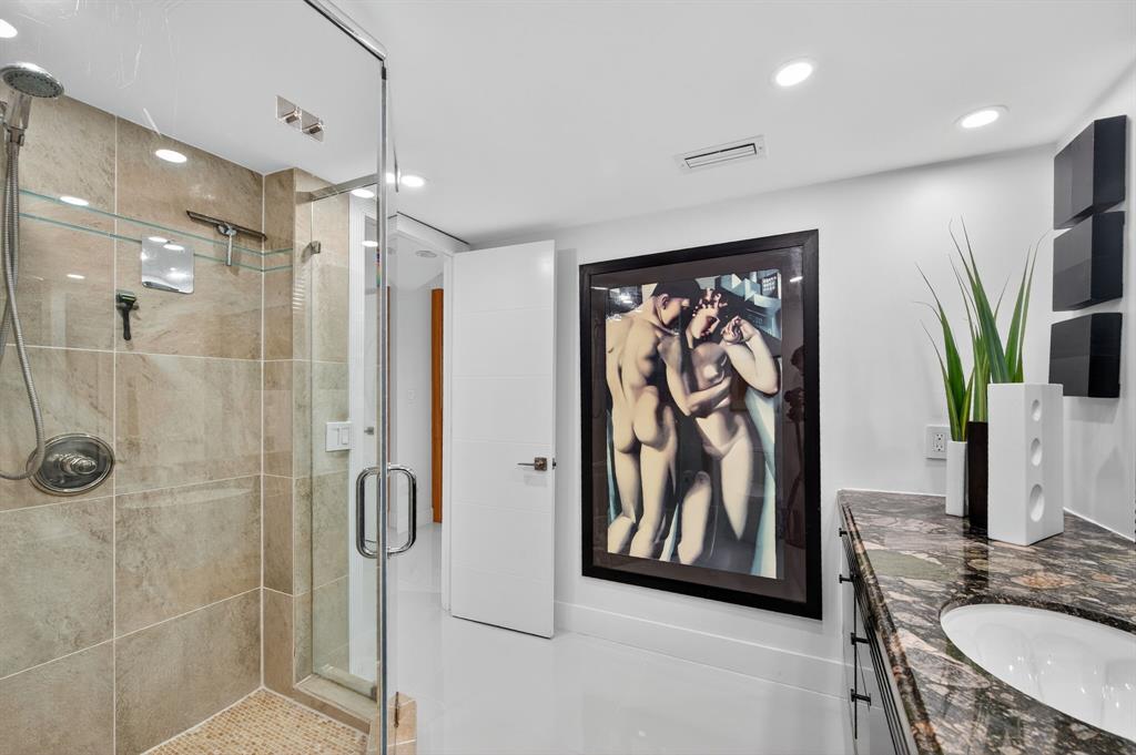 936 Intracoastal Drive, Unit 3C Fort Lauderdale, FL 33304 - Photo 30 of 82 a bathroom with a shower sink and mirror