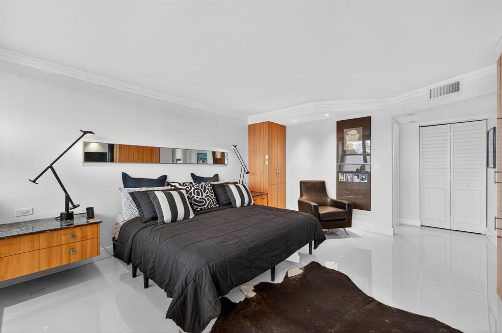 936 Intracoastal Drive, Unit 3C Fort Lauderdale, FL 33304 - Photo 33 of 82 a bedroom with a bed and wooden floor