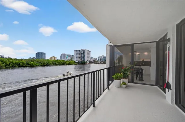 a living room with furniture and floor to ceiling window