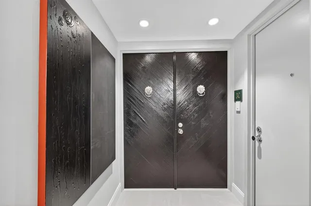 a living room with furniture and a mirror