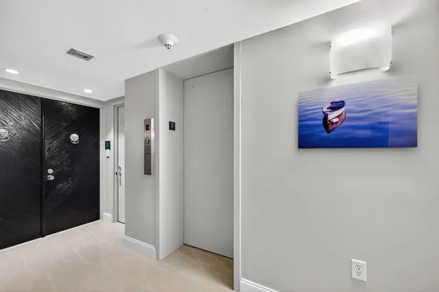 a view of an entryway with wooden floor and cabinet