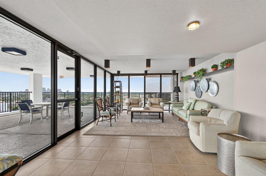 936 Intracoastal Drive, Unit 3C Fort Lauderdale, FL 33304 - Photo 51 of 82 a living room with fireplace furniture and a large window