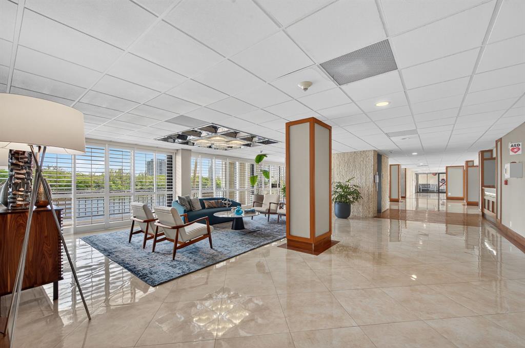 936 Intracoastal Drive, Unit 3C Fort Lauderdale, FL 33304 - Photo 65 of 82 a living room with furniture and a chandelier