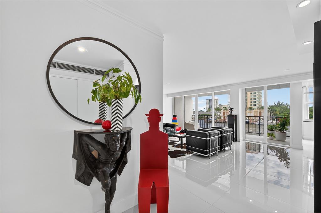 936 Intracoastal Drive, Unit 3C Fort Lauderdale, FL 33304 - Photo 7 of 82 a living room with furniture and a mirror