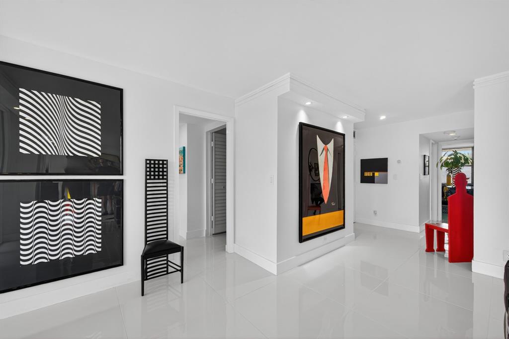 936 Intracoastal Drive, Unit 3C Fort Lauderdale, FL 33304 - Photo 9 of 82 a view of an entryway with wooden floor and cabinet