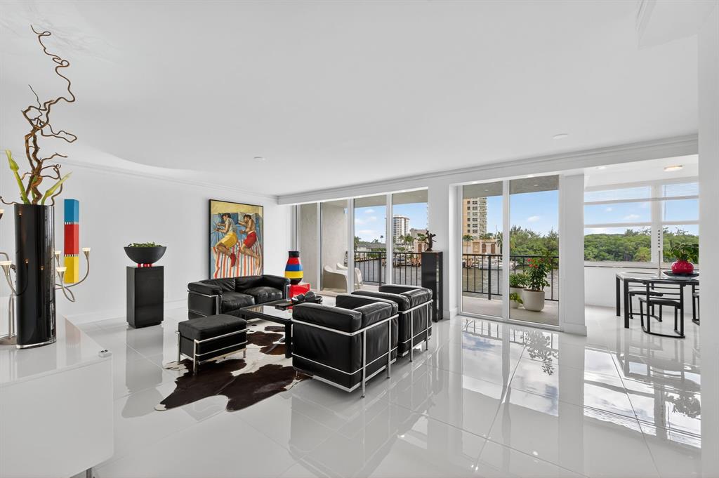 936 Intracoastal Drive, Unit 3C Fort Lauderdale, FL 33304 - Photo 10 of 82 a living room with furniture a flat screen tv and a floor to ceiling window