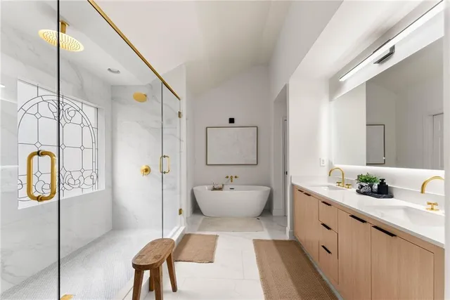 a front view of a house with a dirt yard and a large tree