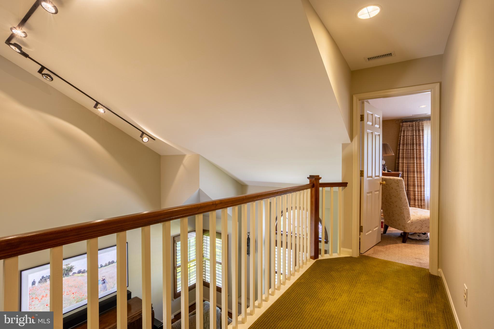 63 Raisin Tree Circle Baltimore, MD 21208 - Photo 24 of 57 a view of a hallway with wooden floor and staircase
