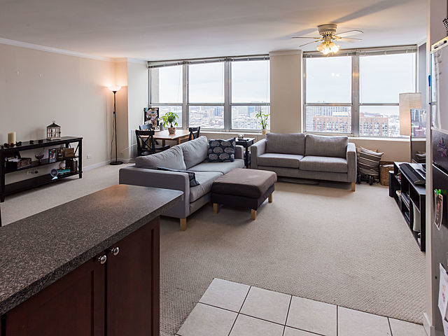 655 West Irving Park Road, Unit 3206 Chicago, IL 60613 - Photo 12 of 20 a living room with furniture and a flat screen tv
