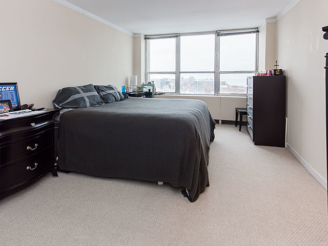 655 West Irving Park Road, Unit 3206 Chicago, IL 60613 - Photo 15 of 20 a bedroom with a bed and wooden floor