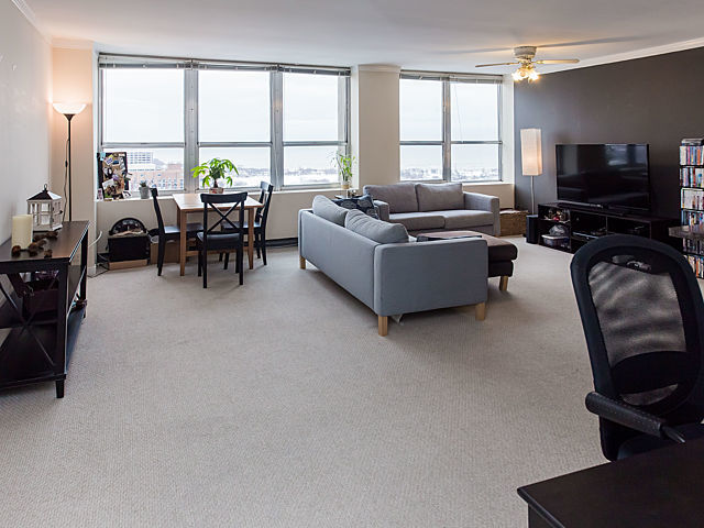 655 West Irving Park Road, Unit 3206 Chicago, IL 60613 - Photo 5 of 20 a living room with furniture and a flat screen tv