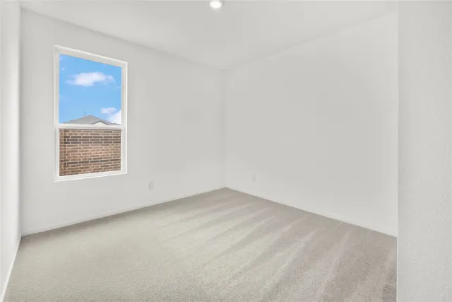 a kitchen with stainless steel appliances a sink a stove a microwave a refrigerator a white cabinets and wooden floor