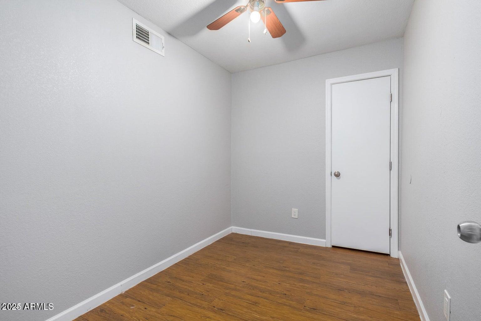 18202 North Cave Creek Road, Unit 134 Phoenix, AZ 85032 - Photo 7 of 10 a view of an empty room with wooden floor