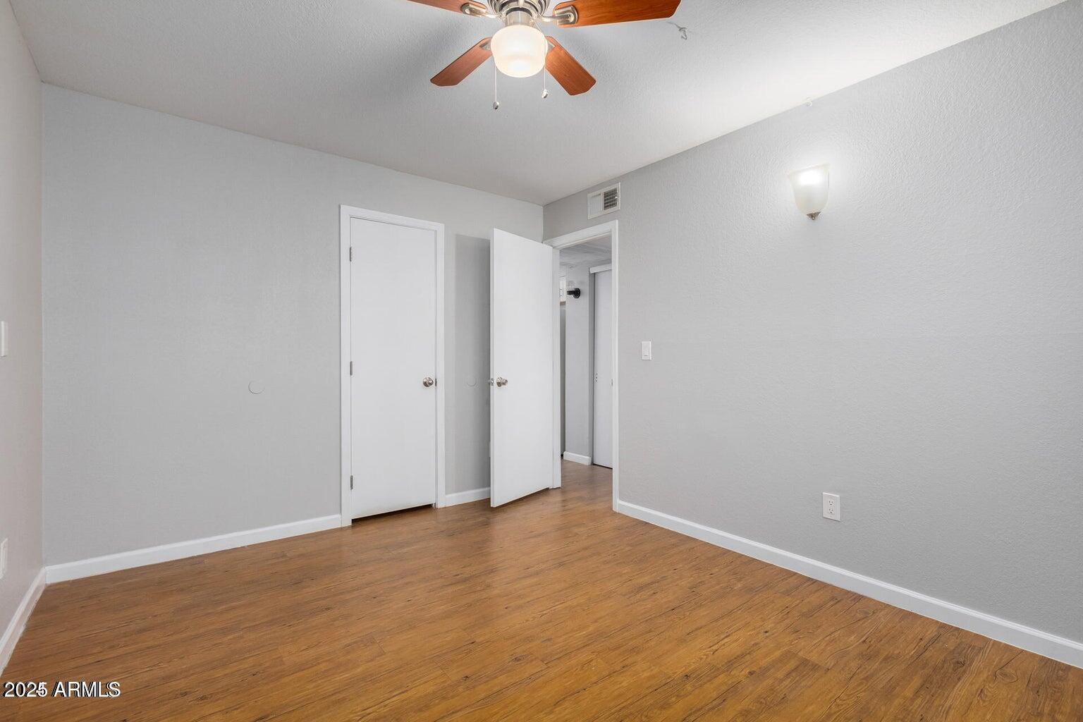18202 North Cave Creek Road, Unit 134 Phoenix, AZ 85032 - Photo 9 of 10 a view of an empty room with wooden floor