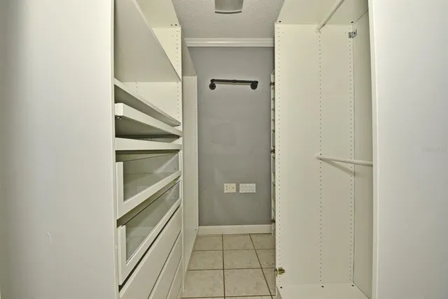 a view of walk in closet with empty racks