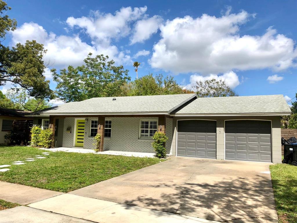 2717 Scarlet Road Winter Park, FL 32792 - Photo 2 of 31 a front view of a house with a garden