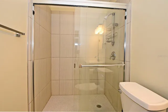 a bathroom with a shower and toilet