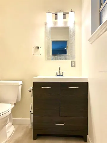 a bathroom with a sink a mirror and a toilet