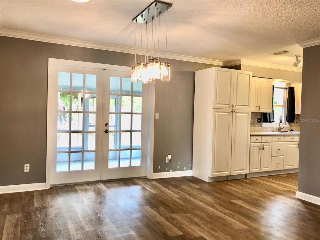 2717 Scarlet Road Winter Park, FL 32792 - Photo 3 of 31 a view of a kitchen with a refrigerator wooden floor and a window