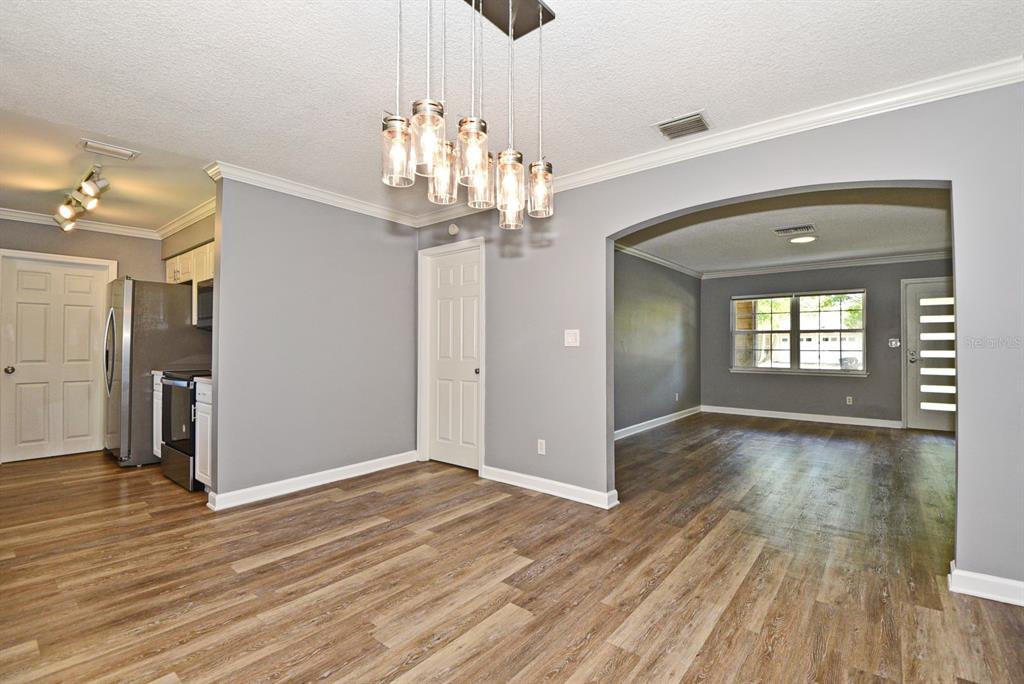 2717 Scarlet Road Winter Park, FL 32792 - Photo 8 of 31 a view of a room with wooden floor chandelier and entryway