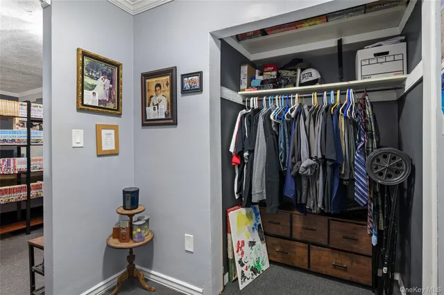 a view of walk in closet with clothes and shoes