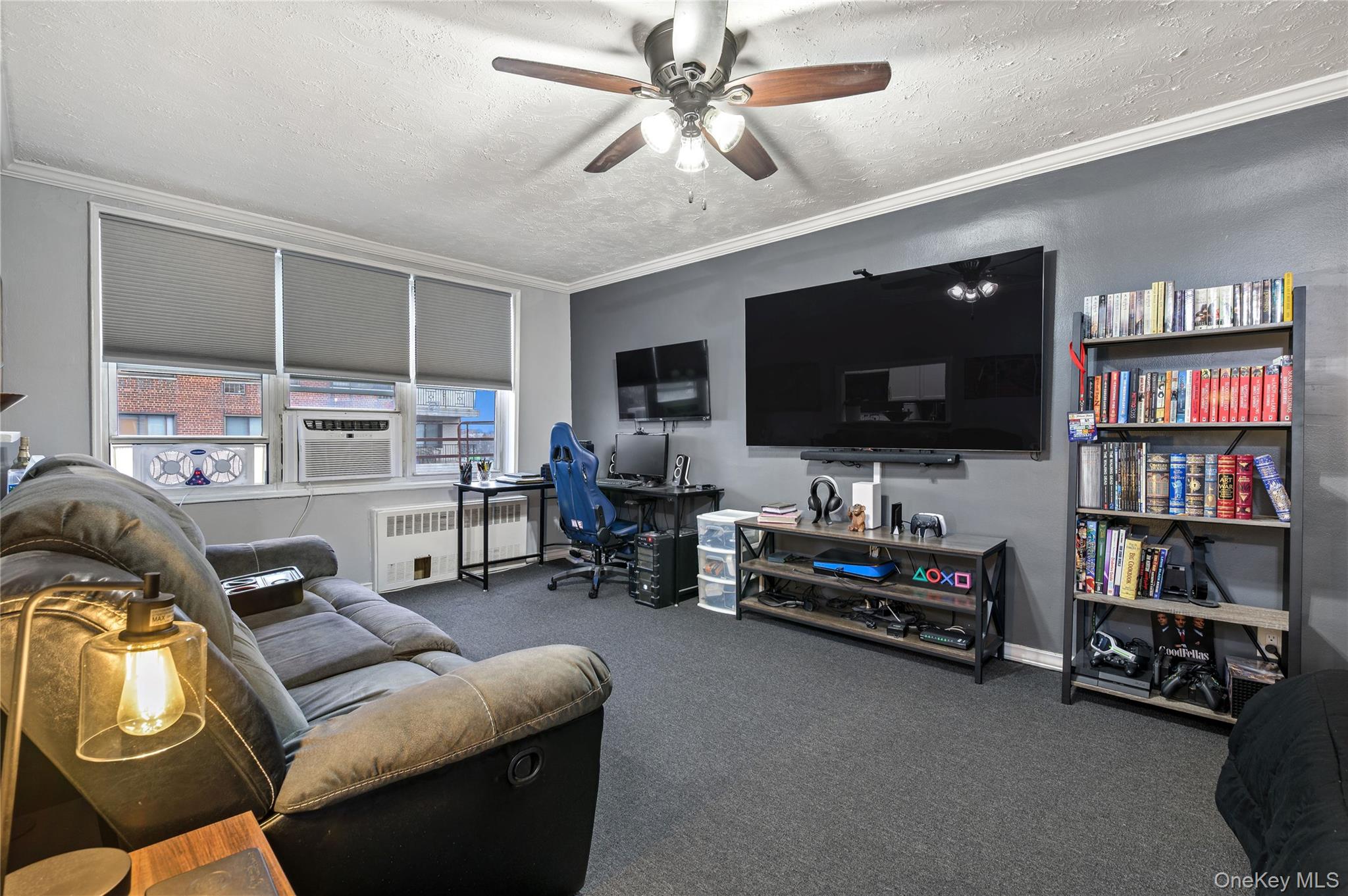 365 Bronx River Road, Unit 7C Yonkers, NY 10704 - Photo 2 of 13 a living room with furniture and a flat screen tv