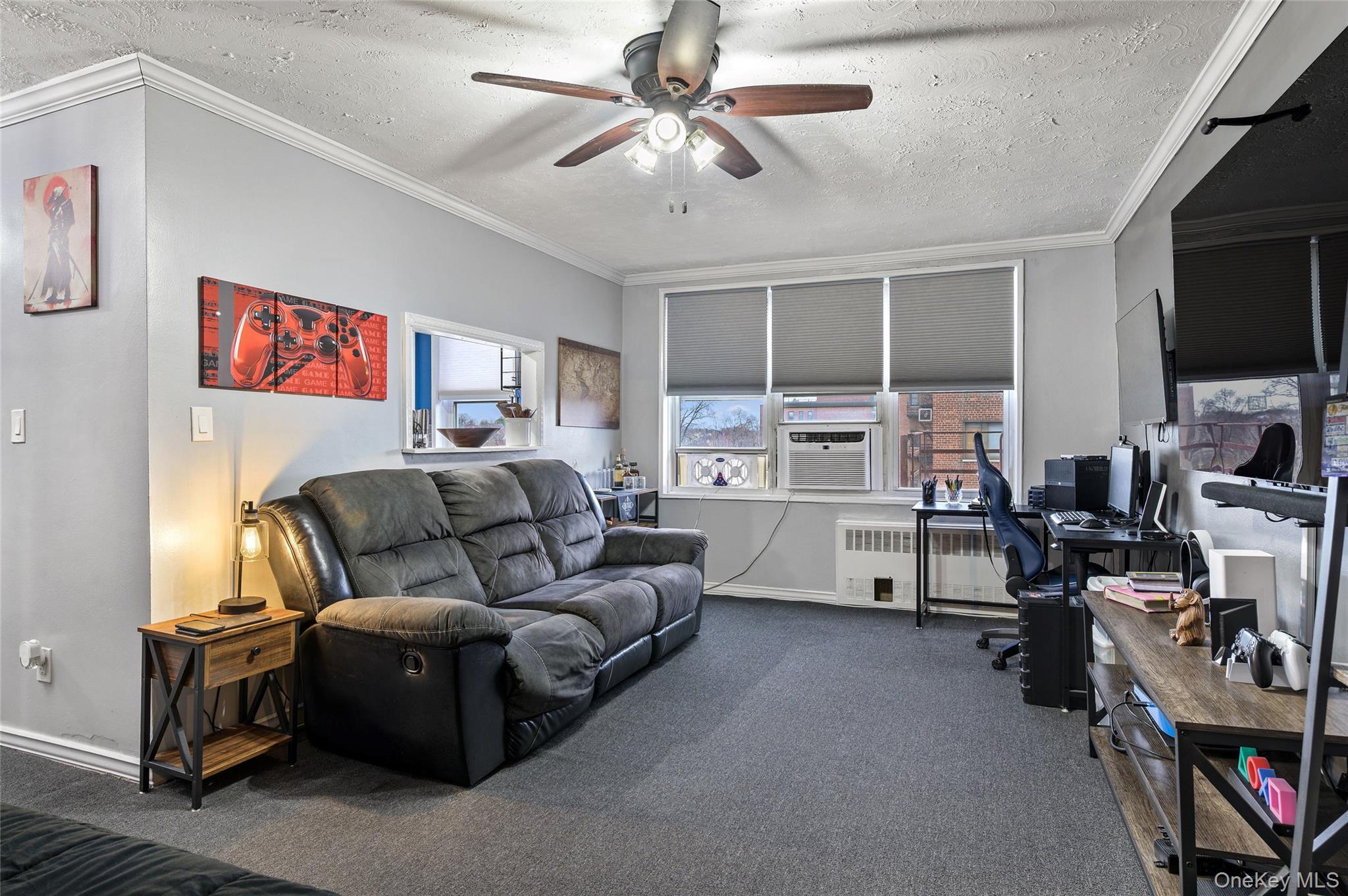 365 Bronx River Road, Unit 7C Yonkers, NY 10704 - Photo 3 of 13 a living room with furniture and a flat screen tv