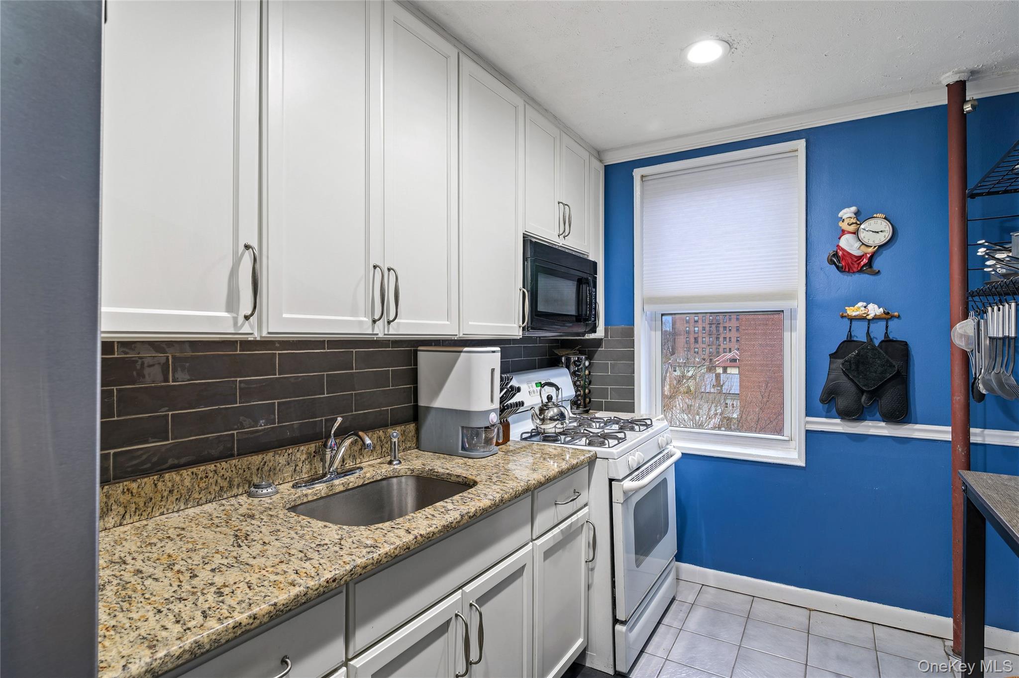365 Bronx River Road, Unit 7C Yonkers, NY 10704 - Photo 6 of 13 a kitchen with stainless steel appliances granite countertop a sink stove and cabinets