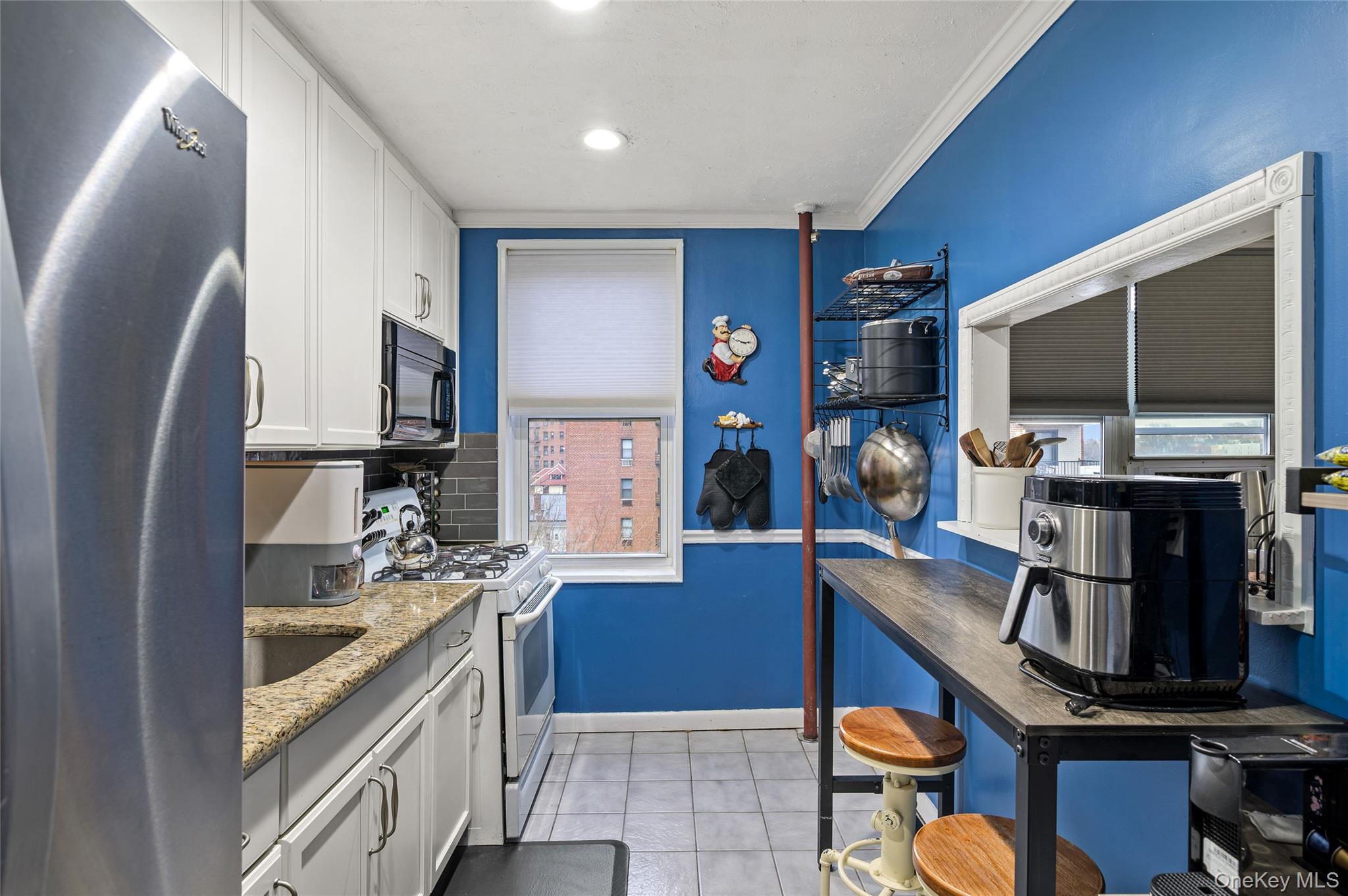 365 Bronx River Road, Unit 7C Yonkers, NY 10704 - Photo 7 of 13 a kitchen with a sink stove and microwave