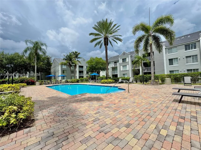 a view of a swimming pool with palm trees