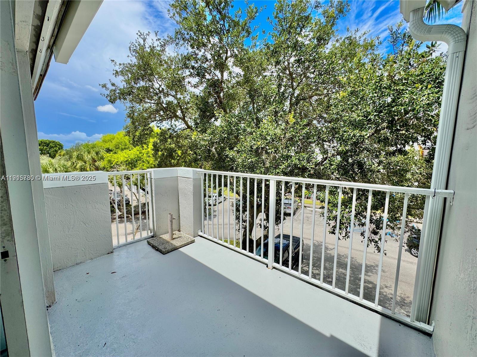 677 Southwest 111th Avenue, Unit 303 Pembroke Pines, FL 33025 - Photo 8 of 19 a balcony with trees in the background