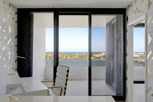a view of a living room with a floor to ceiling window
