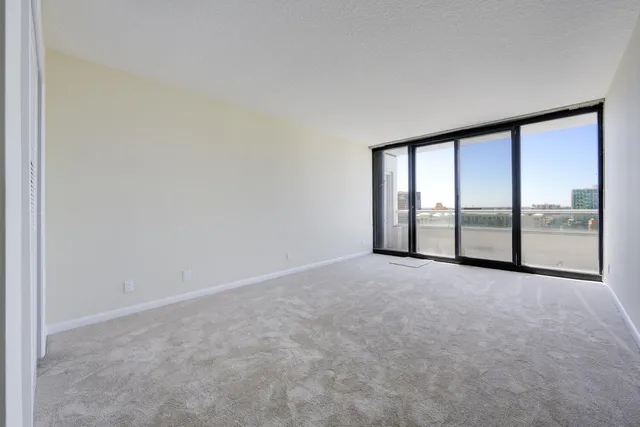 an empty room with windows and city view