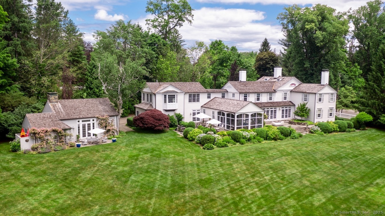 an aerial view of a house with garden space and trees