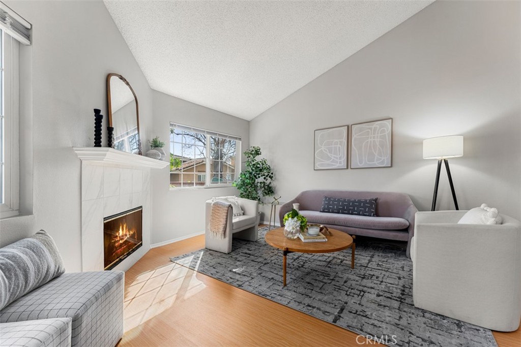 10062 Base Line Road Rancho Cucamonga, CA 91701 - Photo 1 of 1 a living room with furniture and a fireplace