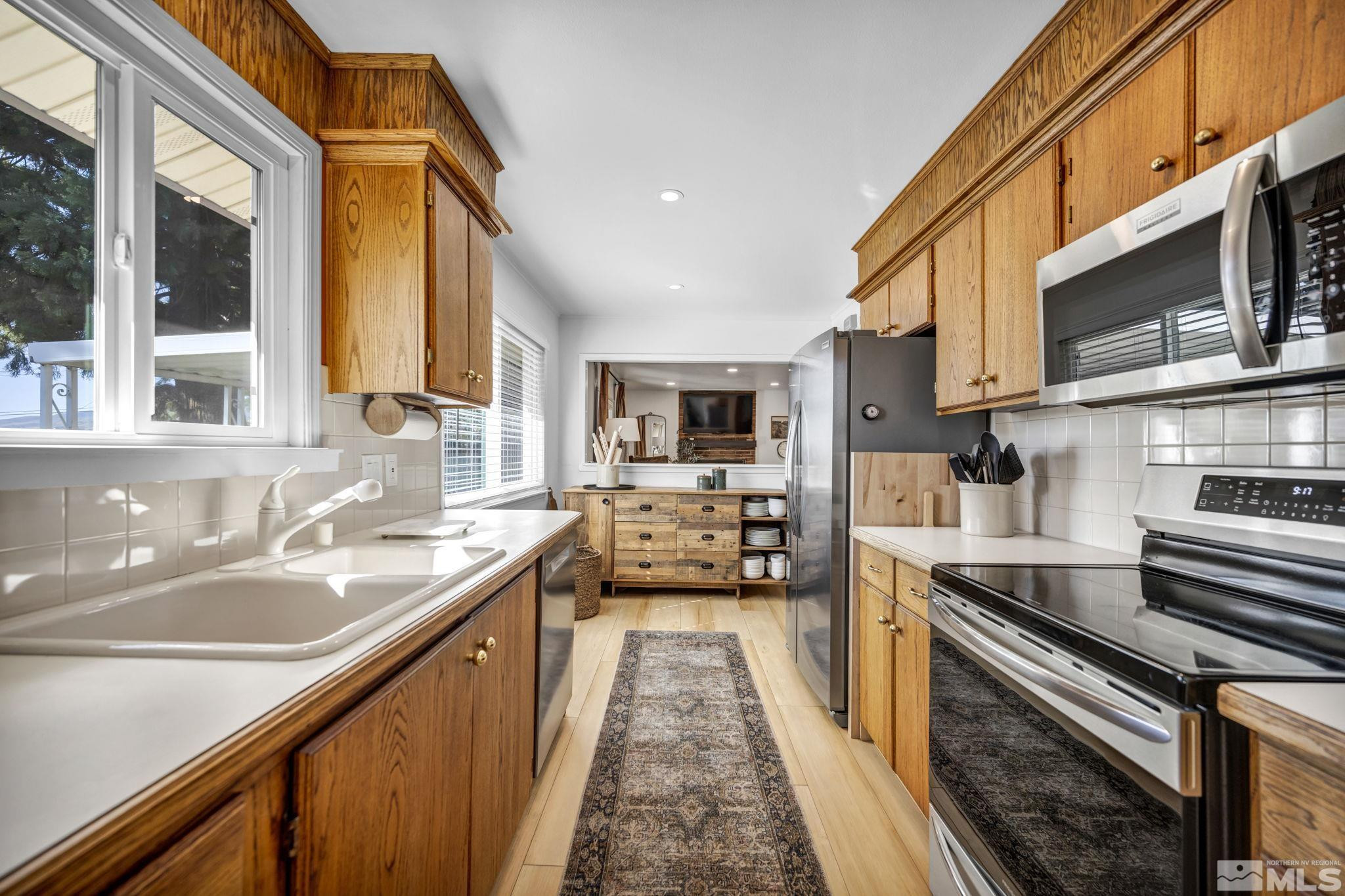 770 Rhode Island Drive Reno, NV 89503 - Photo 15 of 19 a kitchen with stainless steel appliances a sink stove and cabinets